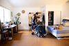 Jane Morgan rides at the back of Conner Slevin's power wheelchair shortly after its arrival in their home in Portland, Ore., on June 8.