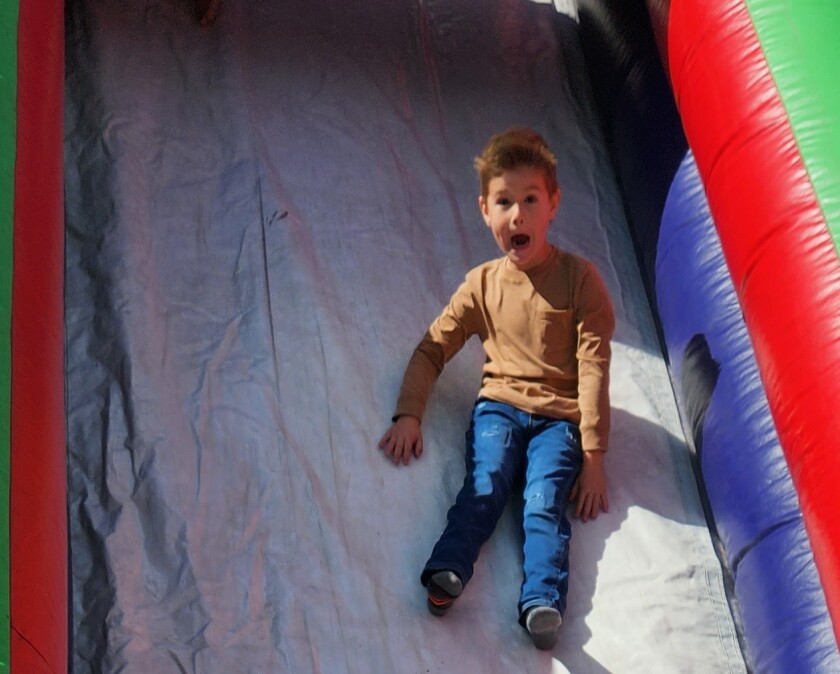 Bridger Christensen, 4, enjoys the bouncy slide during Bethesda's 125th anniversary Legacy Day celebration.